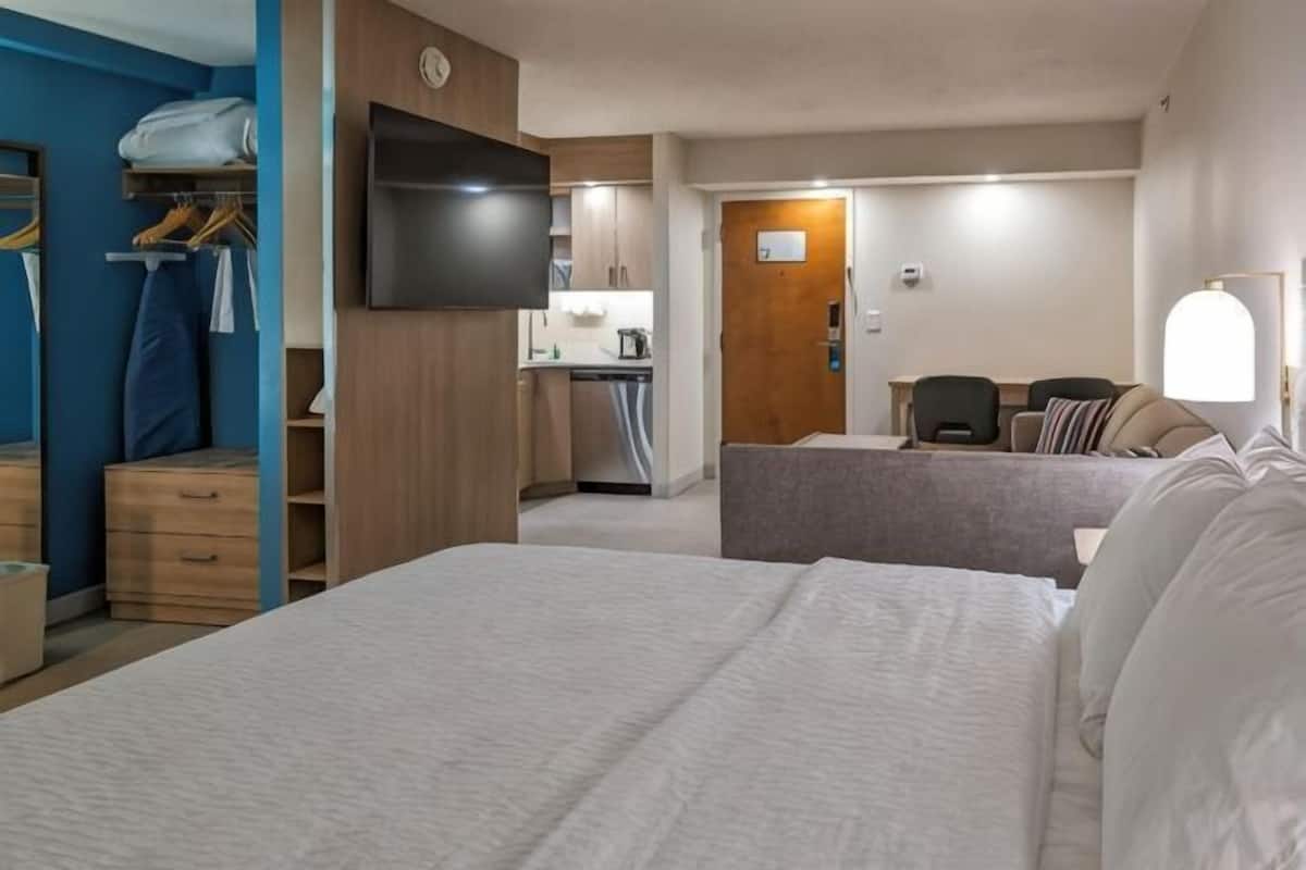 Premium bedding, desk, laptop workspace, blackout drapes