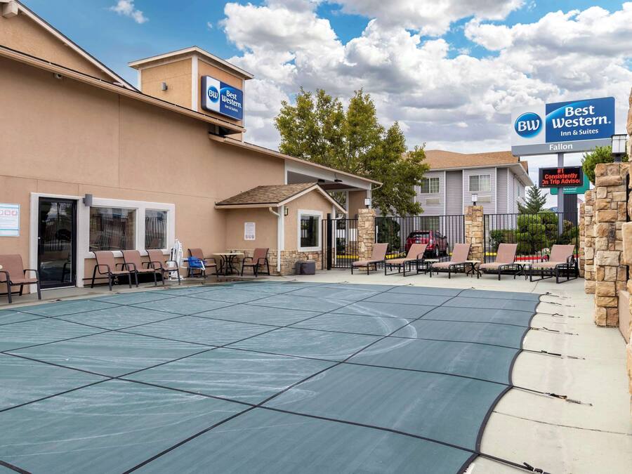 A Best Western Inn & Suites with outdoor seating and a covered patio area.