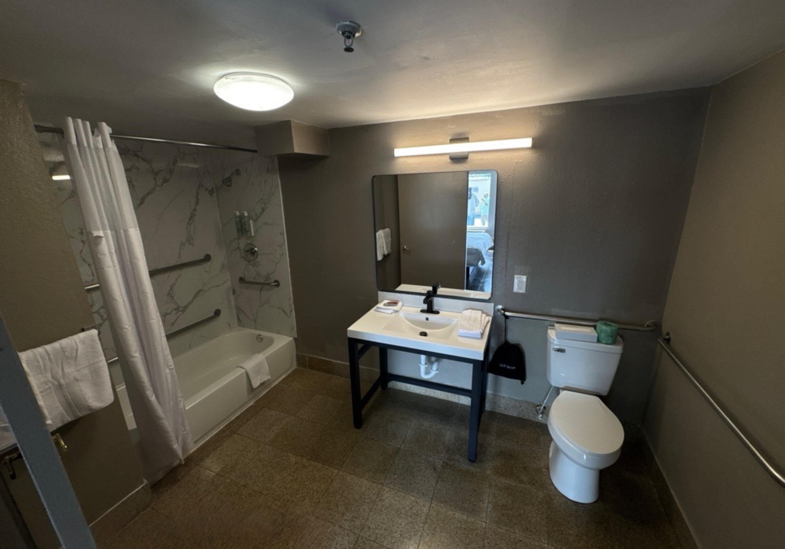 Un baño con bañera, lavabo, inodoro y cortina de ducha.