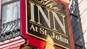 A sign for "The Inn at St. John" with a pineapple emblem. - Inn at St John Portland In-Town (Portland)