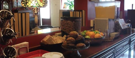 A breakfast bar with various food items, a clock, and a mirror.