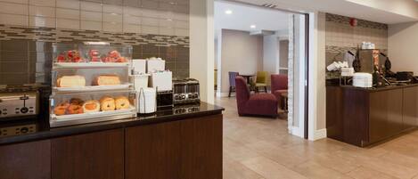 Uma cozinha de hotel com espaço para buffet, área de refeições e uma kitchenette.