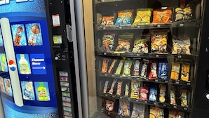 A vending machine with a Pepsi logo and a selection of snacks. - HomeTowne Studios by Red Roof Flint (Flint)