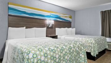 A hotel room with two beds, a large abstract painting on the wall, a nightstand, and a window with curtains.