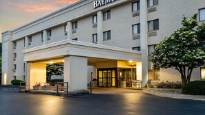 A hotel with a prominent 'Baymont' sign, a covered entrance, and a well-maintained exterior. - Baymont by Wyndham Janesville (Janesville)
