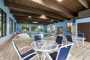 Una piscina techada, sillones reclinables de piscina