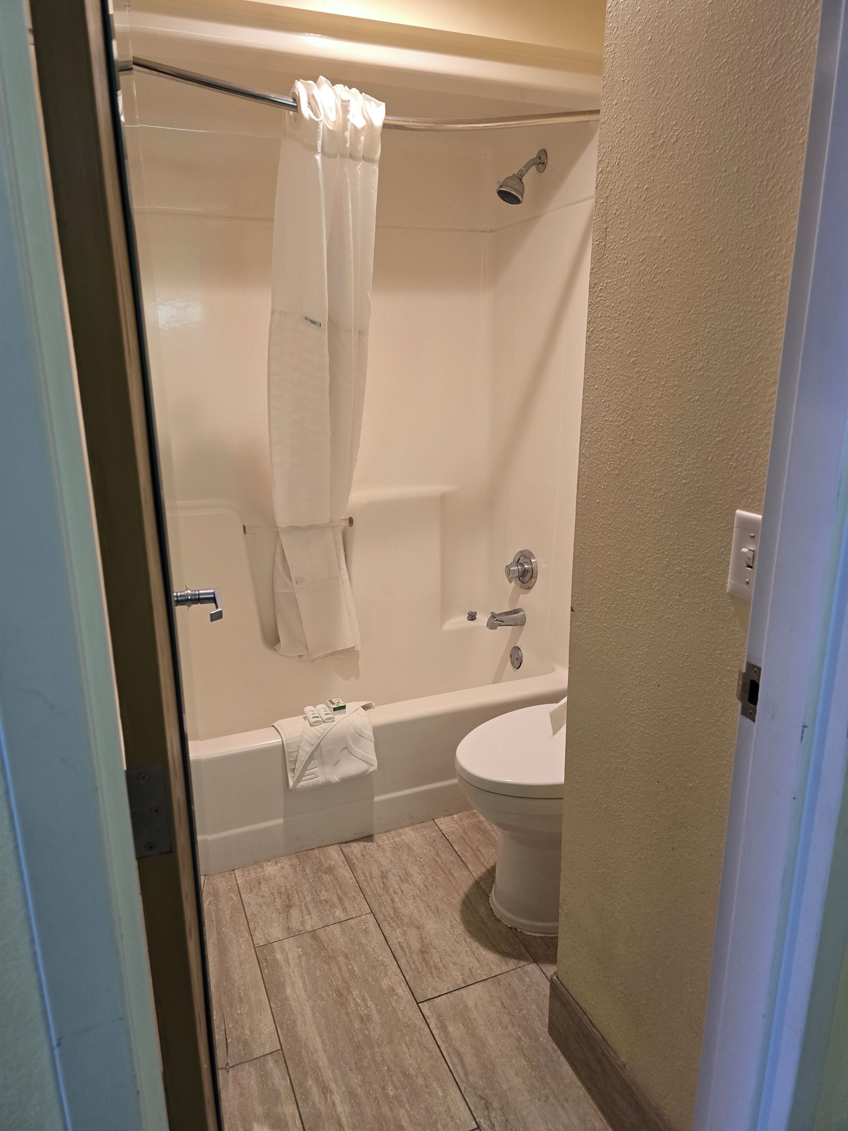 A bathroom with a bathtub, a shower, and a toilet.