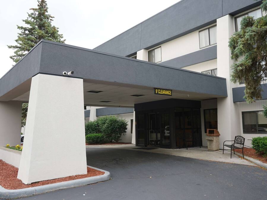 A modern building with a covered entrance labeled "9 Clearance."