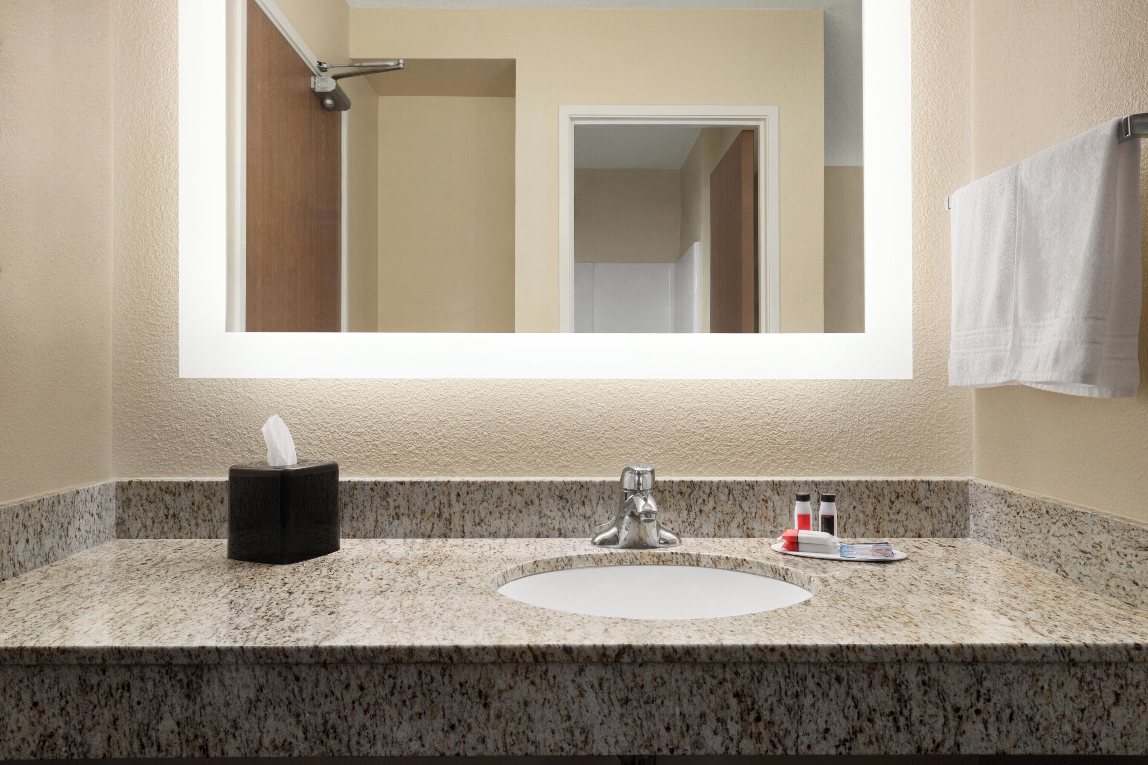 combined shower/bathtub, designer toiletries, hair dryer, towels