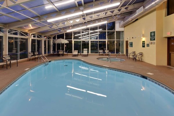 Indoor pool, open 7:00 AM to 11:00 PM, pool umbrellas, sun loungers