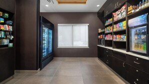 A modern kitchenette with a refrigerator, microwave, and pantry stocked with snacks and beverages. - Courtyard by Marriott Beckley (Beckley)