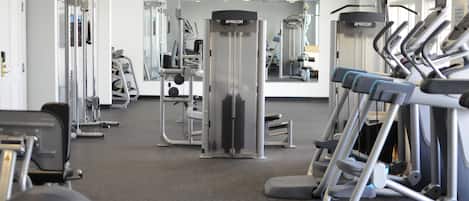 A gym with various exercise equipment, including treadmills and weight machines.