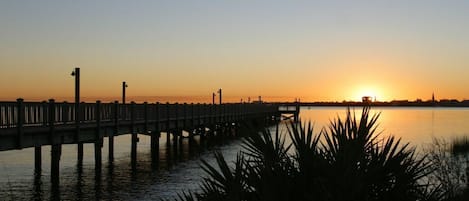 Un muelle que se adentra en aguas tranquilas durante el atardecer.