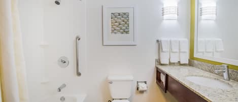 A modern bathroom with a bathtub, toilet, and sink.