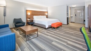 A hotel room with a bed, a desk, a chair, and a sofa. - Holiday Inn Express Hope by IHG (Hope)
