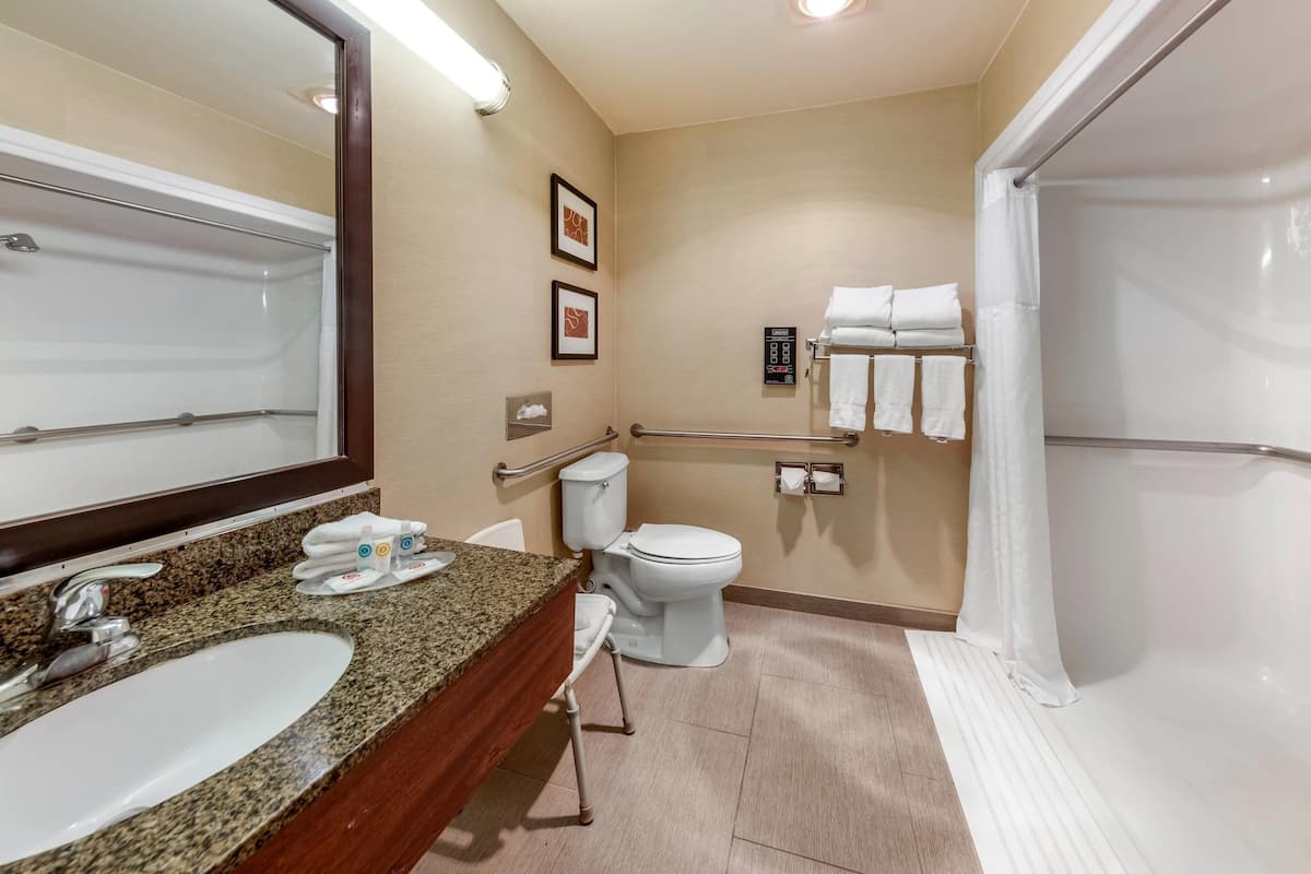 A bathroom with a sink, toilet, and shower.
