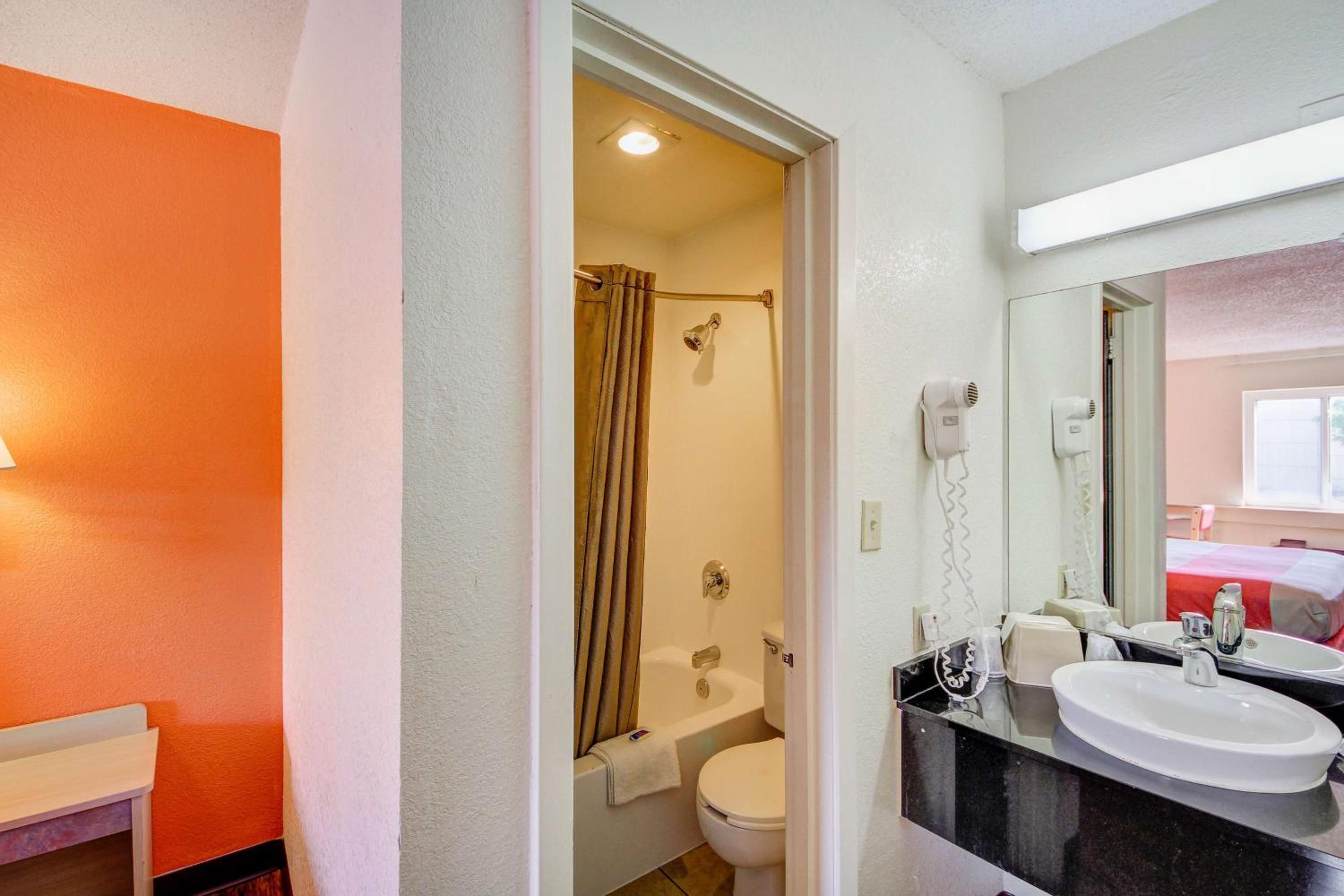 A bathroom with a bathtub, toilet, and sink.