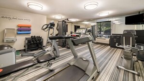A gym with treadmills, weight machines, and exercise mats. - Sonesta Simply Suites Hampton (Hampton)