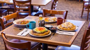 A restaurant table with a meal, including a taco, a bowl of soup, and a dessert. - Hualapai Lodge (Peach Springs)