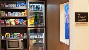 A food display with snacks, drinks, and a microwave. - Fairfield Inn by Marriott Greenville-Spartanburg Airport (Greenville)