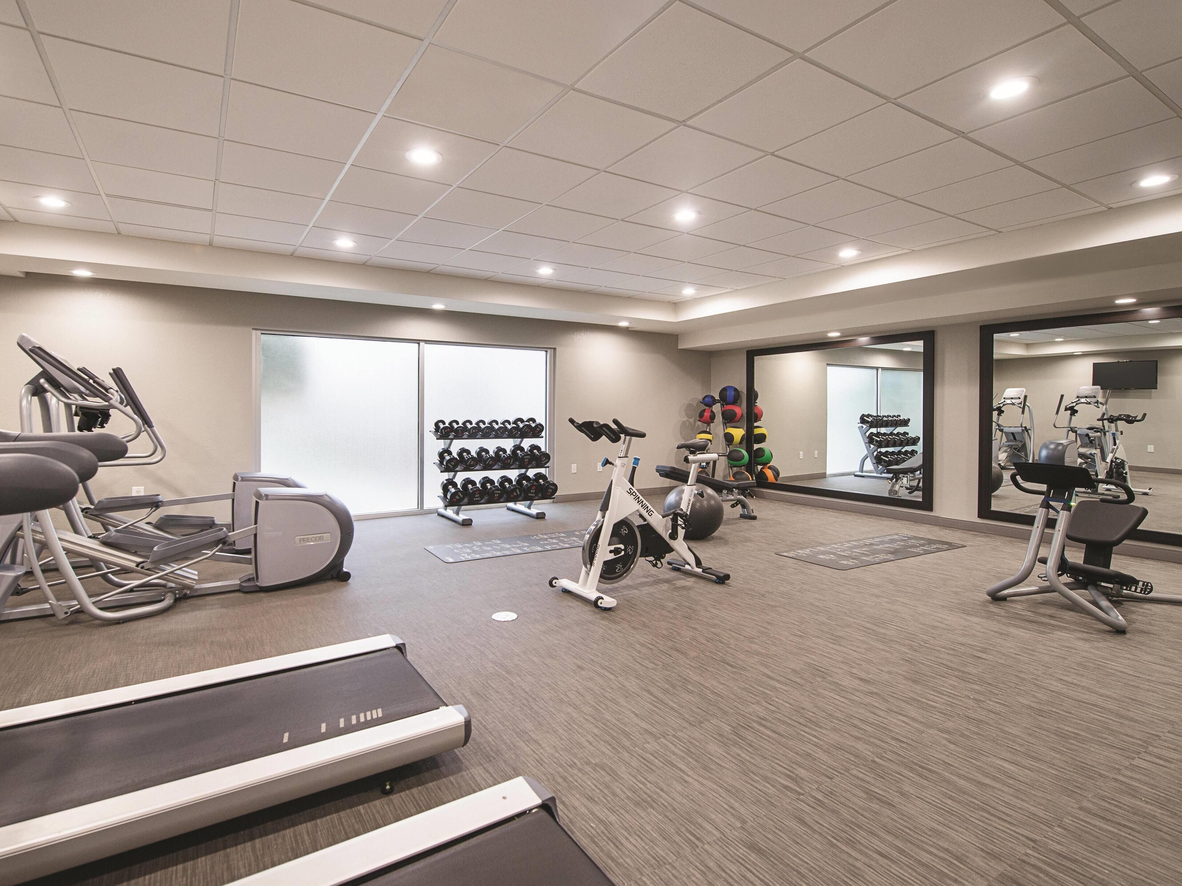 A gym with treadmills, stationary bikes, and weight machines.