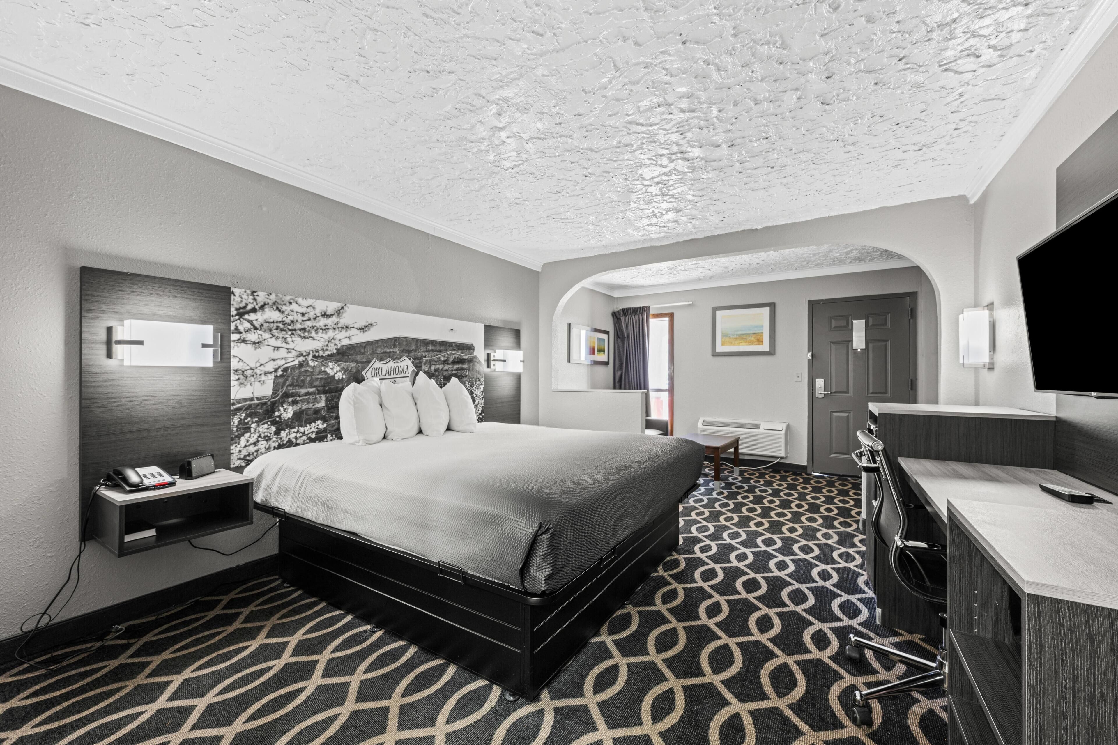 Suite, 1 King Bed, Non Smoking | Desk, laptop workspace, blackout drapes, iron/ironing board