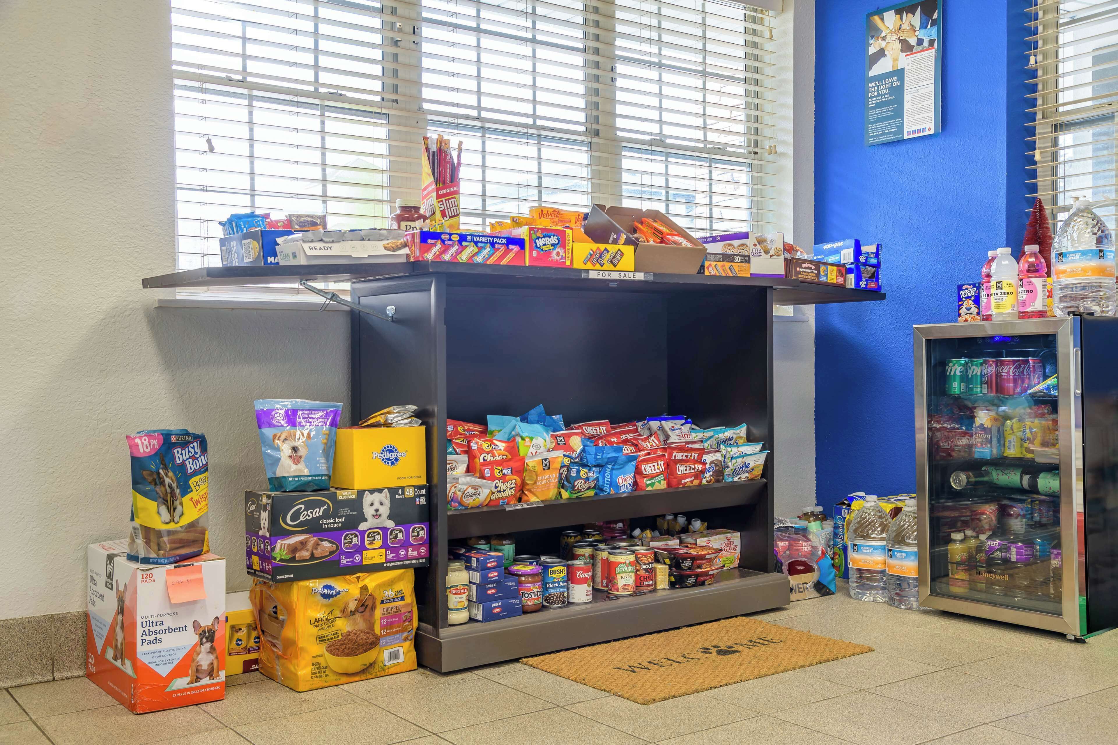 A pet store with shelves stocked with pet food, treats, and supplies.