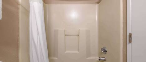 A bathroom with a bathtub, a shower, and a toilet.