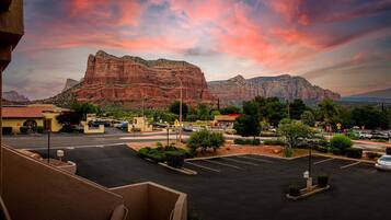 A parking lot with a mountain in the background.