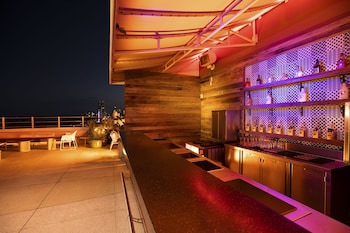 A hotel with a central courtyard, palm trees, and a neon sign. at Clevelander Hotel – Adults Only