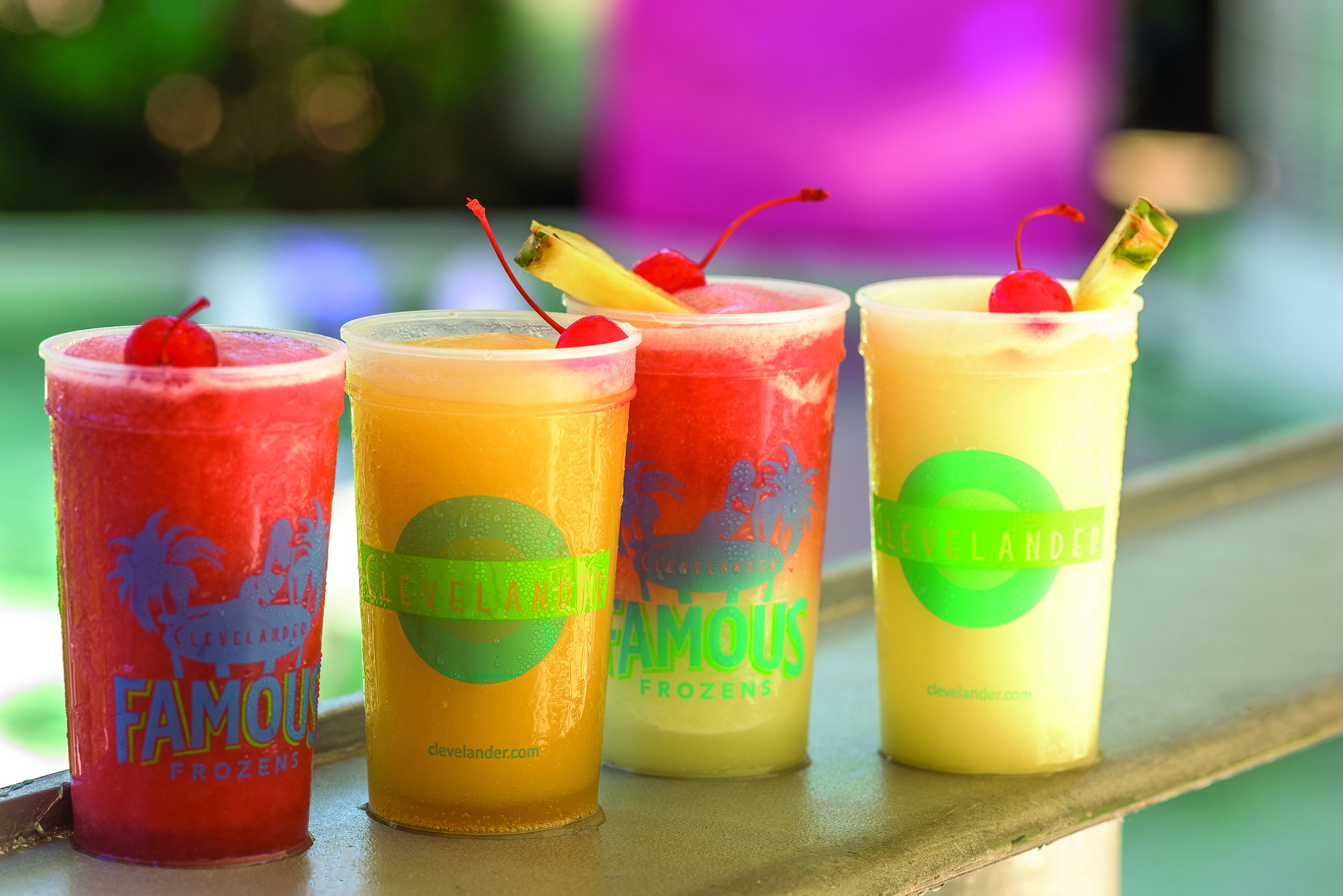Three glasses of frozen drinks on a tray.