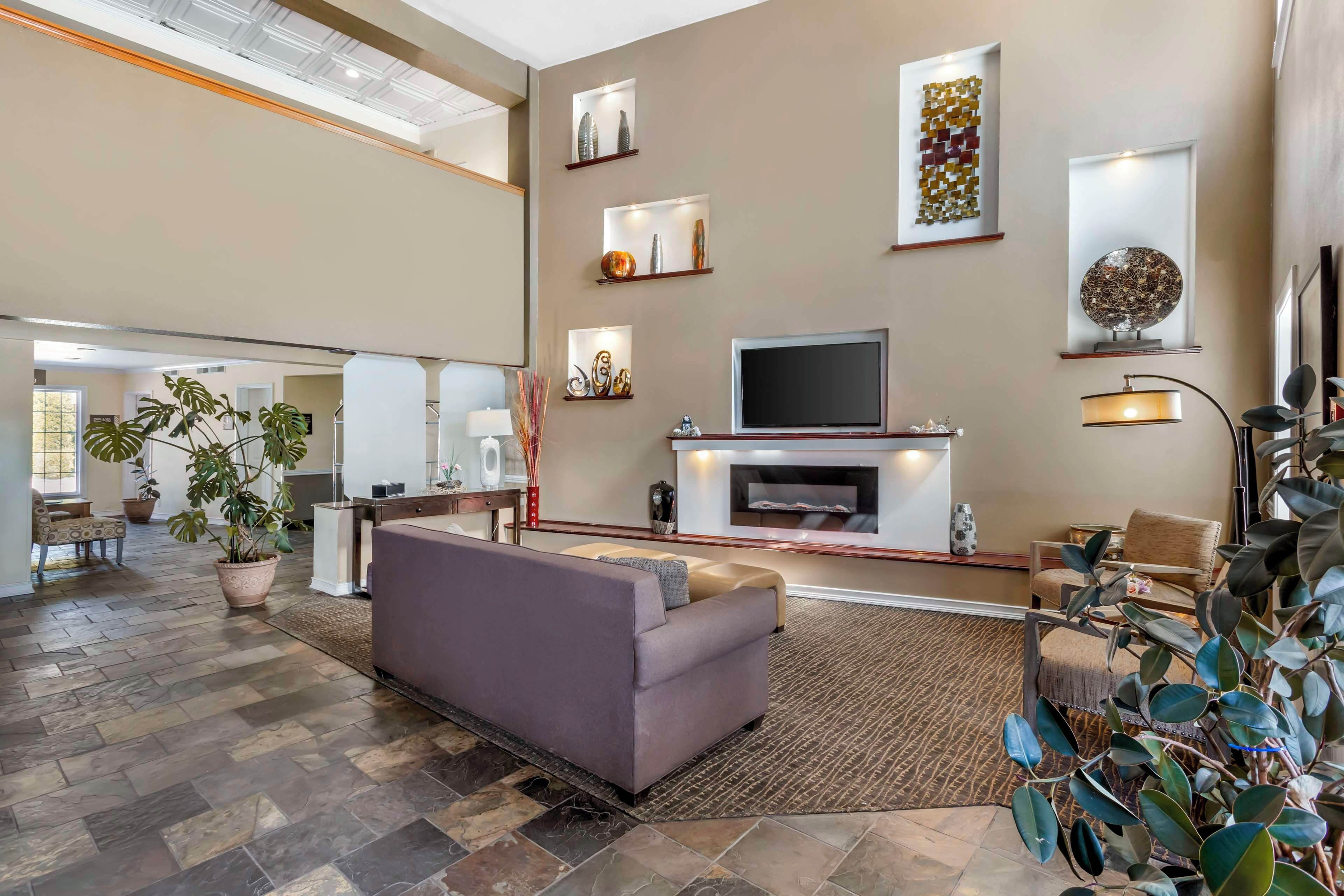 A spacious living area with a fireplace, seating, and decorative items.