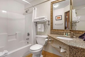 A modern bathroom with a shower, toilet, and sink.