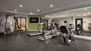 A fitness center with treadmills, elliptical machines, and weight machines. - Spark by Hilton Houston Bush Intercontinental Airport (Houston)