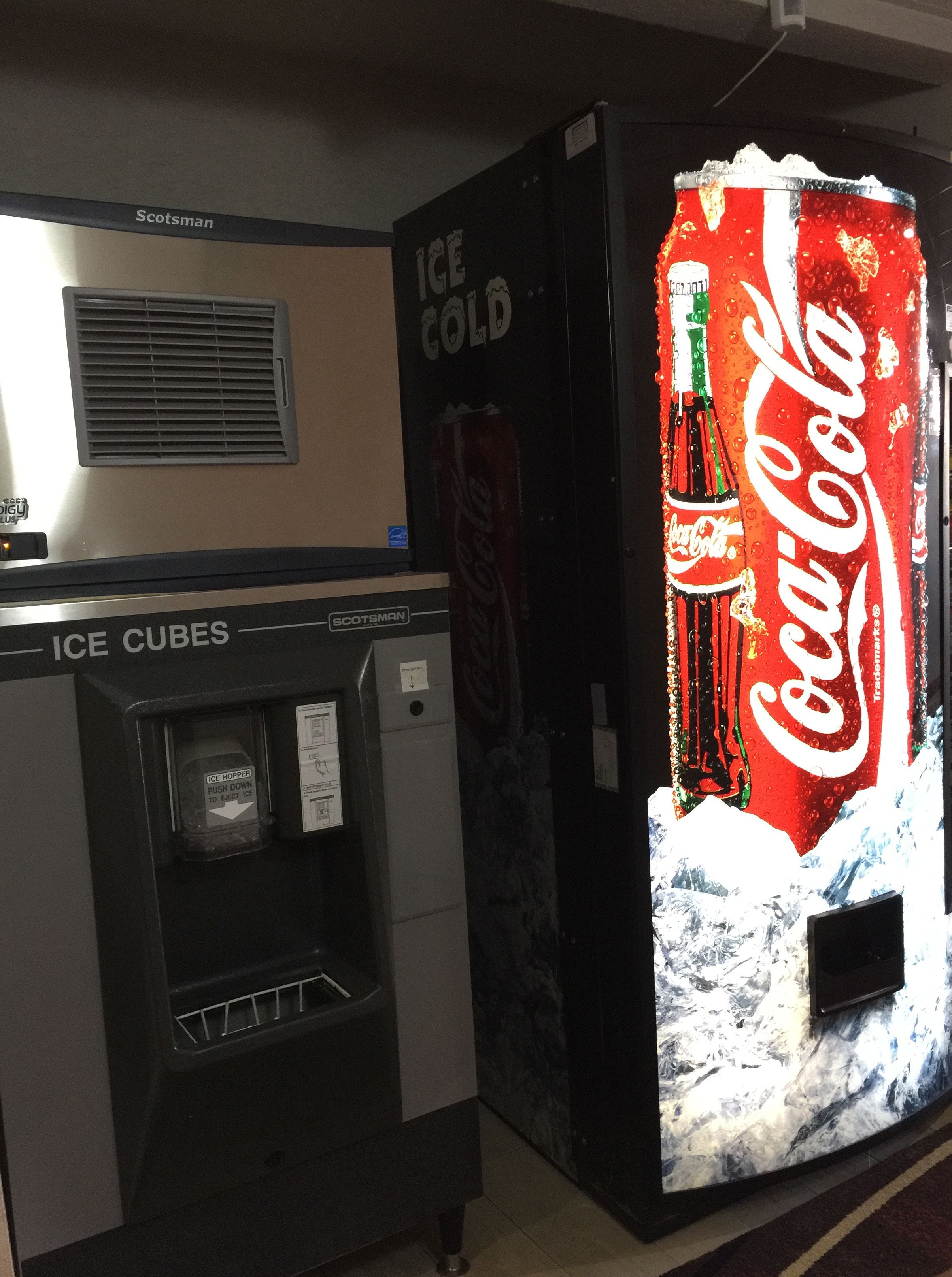 A vending machine with an ice dispenser and a Coca-Cola branded machine.