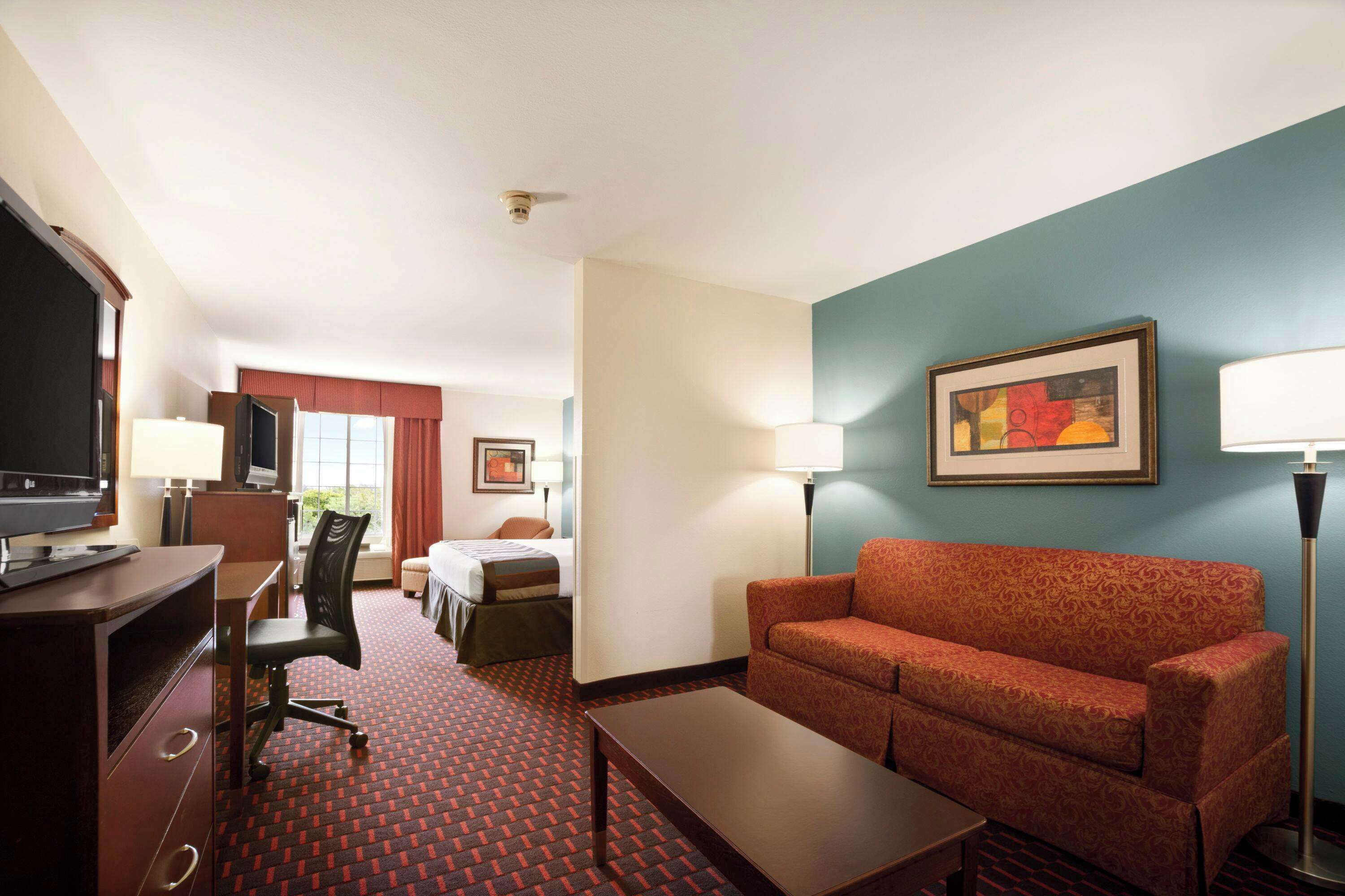 suite, 1 king bed, microwave | in-room safe, desk, laptop workspace, blackout curtains