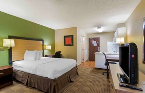 Relax in this cozy space with a comfortable bed, desk, and seating area.