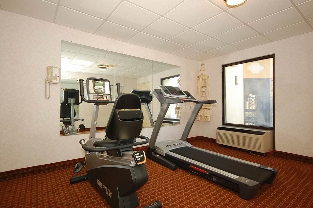 A hotel fitness room with a treadmill, elliptical, and stationary bike.
