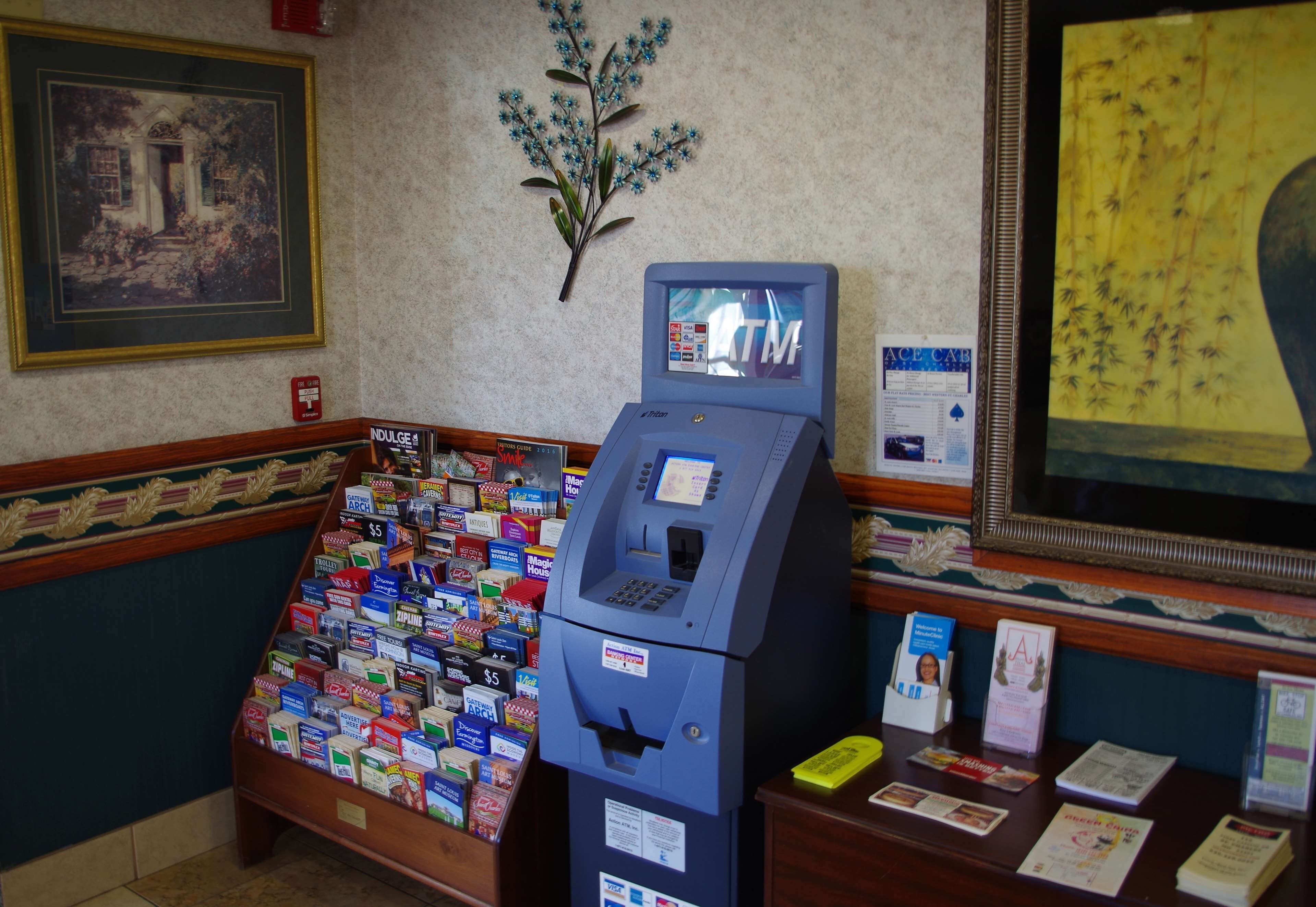 A self-service kiosk with a payment terminal, surrounded by a display of various products.