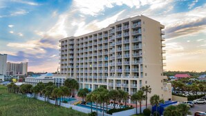 A multi-story hotel with balconies, a swimming pool, and a view of the surrounding area. - Ocean Drive Beach & Golf Resort (North Myrtle Beach)
