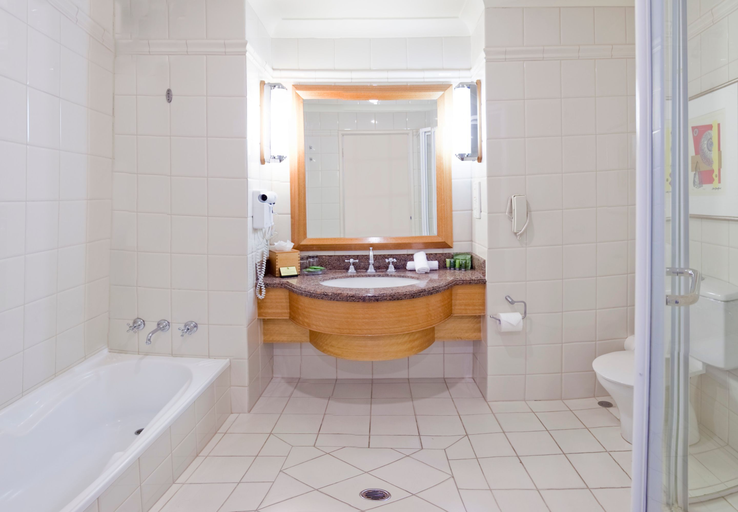 A modern bathroom with a bathtub, sink, and toilet.