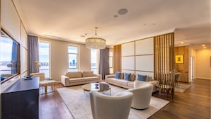 A modern living room with a sofa set, a coffee table, and a desk.