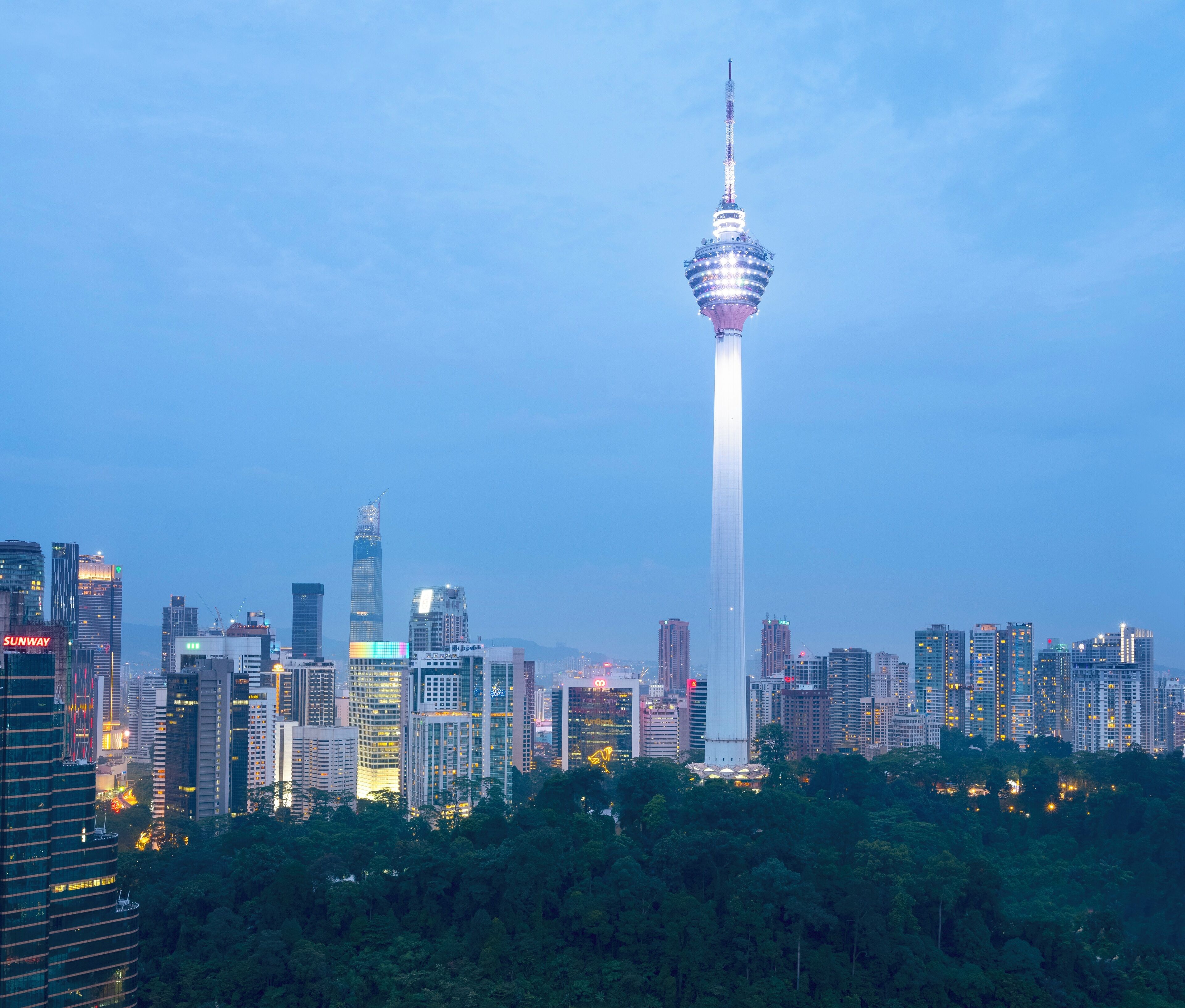 A cityscape with a prominent tower and surrounding high-rise buildings.