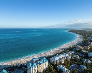 A resort with multiple buildings, a beach, and the ocean. - Ports of Call Resort Turks, Tapestry Collection by Hilton (Providenciales)