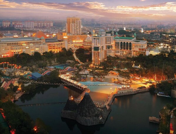 A resort with a large pool, a water slide, and a thatched-roof structure. - Sunway Resort Hotel (Petaling Jaya)