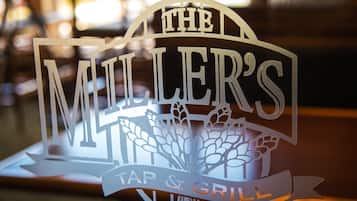 A bar sign with the text "The Miller's Tap & Grill."