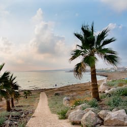 On the beach, sun-loungers, beach umbrellas, windsurfing