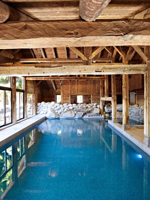 Relax by the indoor pool surrounded by natural surroundings.