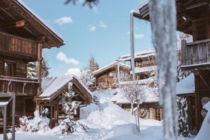 Cozy chalet-style accommodation with a steeply pitched roof and multiple windows.