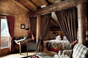 Relax in this inviting bedroom with a large bed, desk, and chair, perfect for unwinding and getting work done.